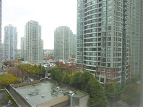 Vancouver apartment for rent - A view of a cityscape with apartment buildings and trees.
