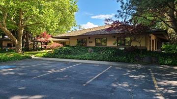 Yakima apartment for rent - a large parking lot in front of a yellow house