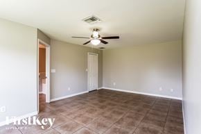 Lehigh Acres house for rent - a living room with a ceiling fan and a tiled floor
