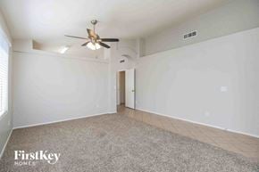 Mesa house for rent - an empty living room with white walls and a ceiling fan