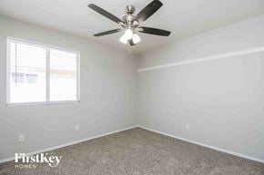 Mesa house for rent - a bedroom with a ceiling fan and a window
