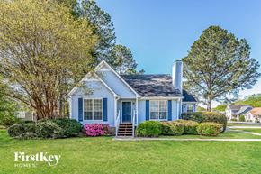 Pinson house for rent - A blue house with a white roof and a chimney is shown.