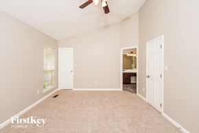 Pinson house for rent - A spacious room with a carpeted floor and a ceiling fan.