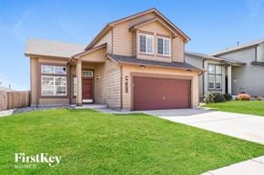 Colorado Springs house for rent - a house with a driveway and lawn in front of it