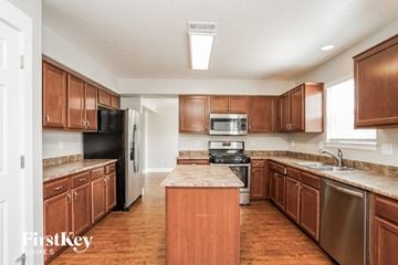 Colorado Springs house for rent - a kitchen with wooden cabinets and stainless steel appliances