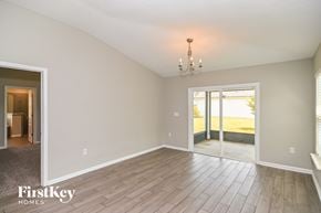 Fernandina Beach house for rent - A room with a chandelier and a sliding glass door.
