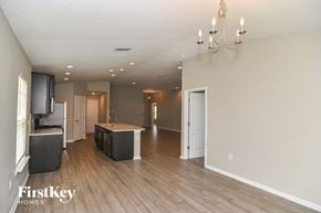 Fernandina Beach house for rent - A spacious living room with a kitchen area in the background.