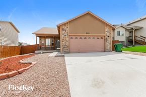 Coloradosprings house for rent - A house with a brown garage door is for sale.