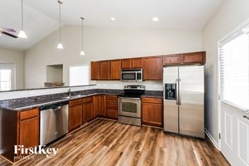 Coloradosprings house for rent - A kitchen with wooden cabinets and stainless steel appliances.