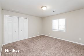 Coloradosprings house for rent - A bedroom with a carpeted floor and a window with blinds.