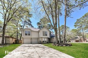 Spring house for rent - a house with a driveway and trees