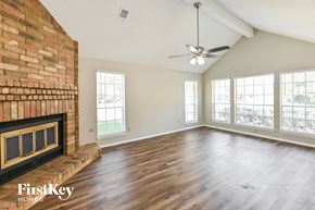 Spring house for rent - the living room has a brick fireplace and hardwood floors
