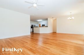 Summerville house for rent - A room with wooden floors and a ceiling fan.