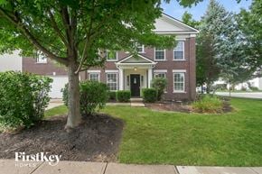 Fishers house for rent - A brick house with a tree in front of it.