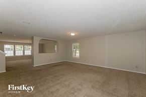 Fishers house for rent - A spacious room with a carpeted floor and a large window.