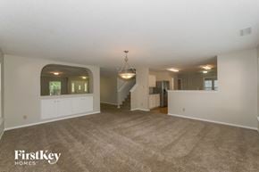 Fishers house for rent - A spacious living room with a staircase and a chandelier.