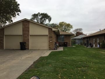 Fremont apartment for rent - A house with a brown garage door and a grey roof.