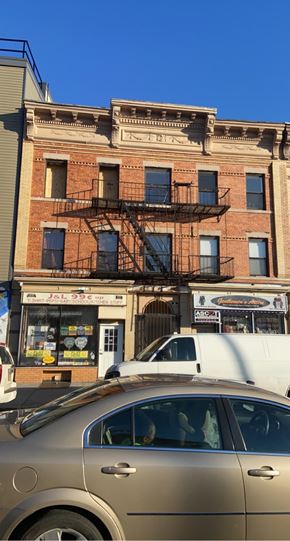 Jersey City apartment for rent - A car is parked in front of a building with a sign that reads "JL 999".