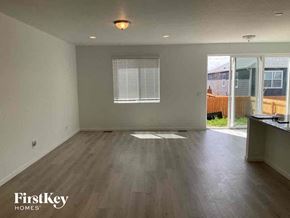 Mead house for rent - an empty living room with wood flooring and a window