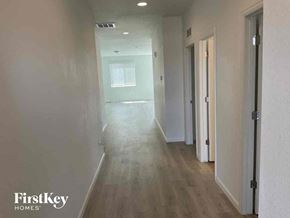 Mead house for rent - an empty hallway with white walls and wood floors