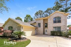 Humble house for rent - a beige brick house with a yellow garage and a driveway