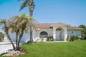 Lehigh Acres house for rent - a house with a palm tree in front of it