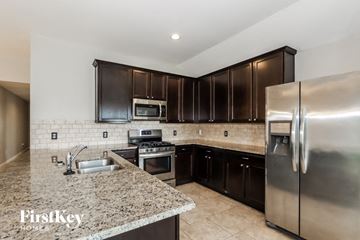Baytown house for rent - a kitchen with stainless steel appliances and granite counter tops