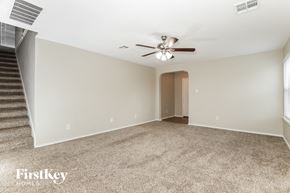 San Antonio house for rent - a living room with a ceiling fan and a carpeted floor