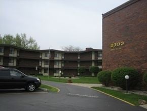 Lansing apartment for rent - a car is parked in front of an apartment building