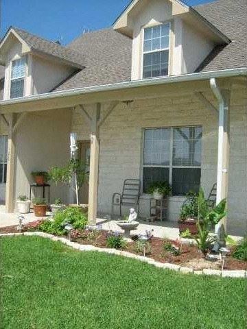 Jarrell house for rent - a house with a lawn and a chair on the porch