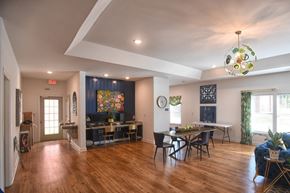 Abbeville apartment for rent - A dining room with a wooden floor and a large painting on the wall.