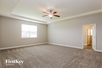 Griffin house for rent - a living room with carpet and a ceiling fan