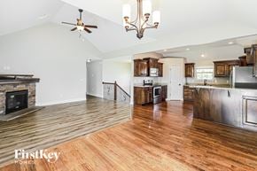 Basehor house for rent - A modern kitchen with wooden floors and a stainless steel refrigerator.