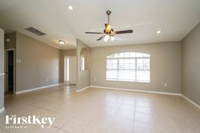 Cape Coral house for rent - an empty living room with a ceiling fan