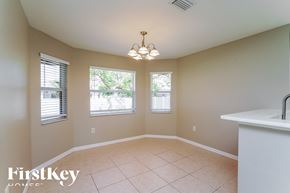 Cape Coral house for rent - an empty dining room with a sink and three windows