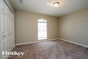 Cape Coral house for rent - a bedroom with carpet and a window and a door