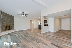 Tucson house for rent - a living room with a ceiling fan and a fireplace