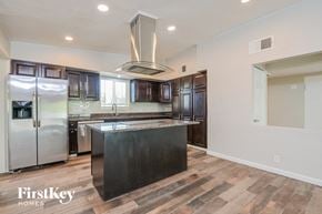 Tucson house for rent - a large kitchen with stainless steel appliances and a large island