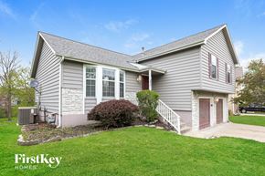 Lee's Summit house for rent - a white house with a lawn and a driveway