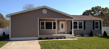 Egg Harbor Township house for rent - a brown house with a front porch and a lawn
