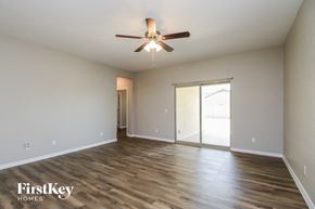 Florence house for rent - A spacious room with a ceiling fan and wooden flooring.