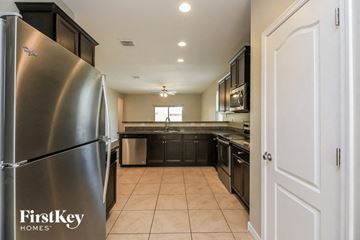 Florence house for rent - A kitchen with a stainless steel refrigerator and black cabinets.
