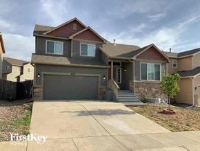 Colorado Springs house for rent - a house with a driveway and a garage door