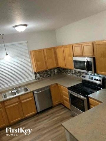 Colorado Springs house for rent - a kitchen with wooden cabinets and stainless steel appliances