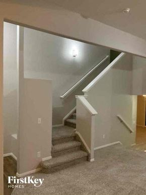 Colorado Springs house for rent - a staircase in a house with a carpeted floor