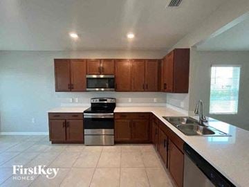 Cape Coral house for rent - a kitchen with a sink and a stove