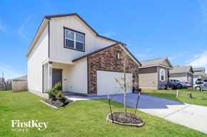 Saint Hedwig house for rent - a white and brick house with a driveway and lawn