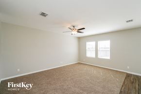 Saint Hedwig house for rent - an empty living room with a ceiling fan and a window