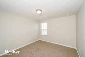 Saint Hedwig house for rent - a bedroom with white walls and carpet and a window
