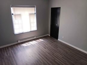 Indianapolis apartment for rent - A room with a black door and a window with blinds.